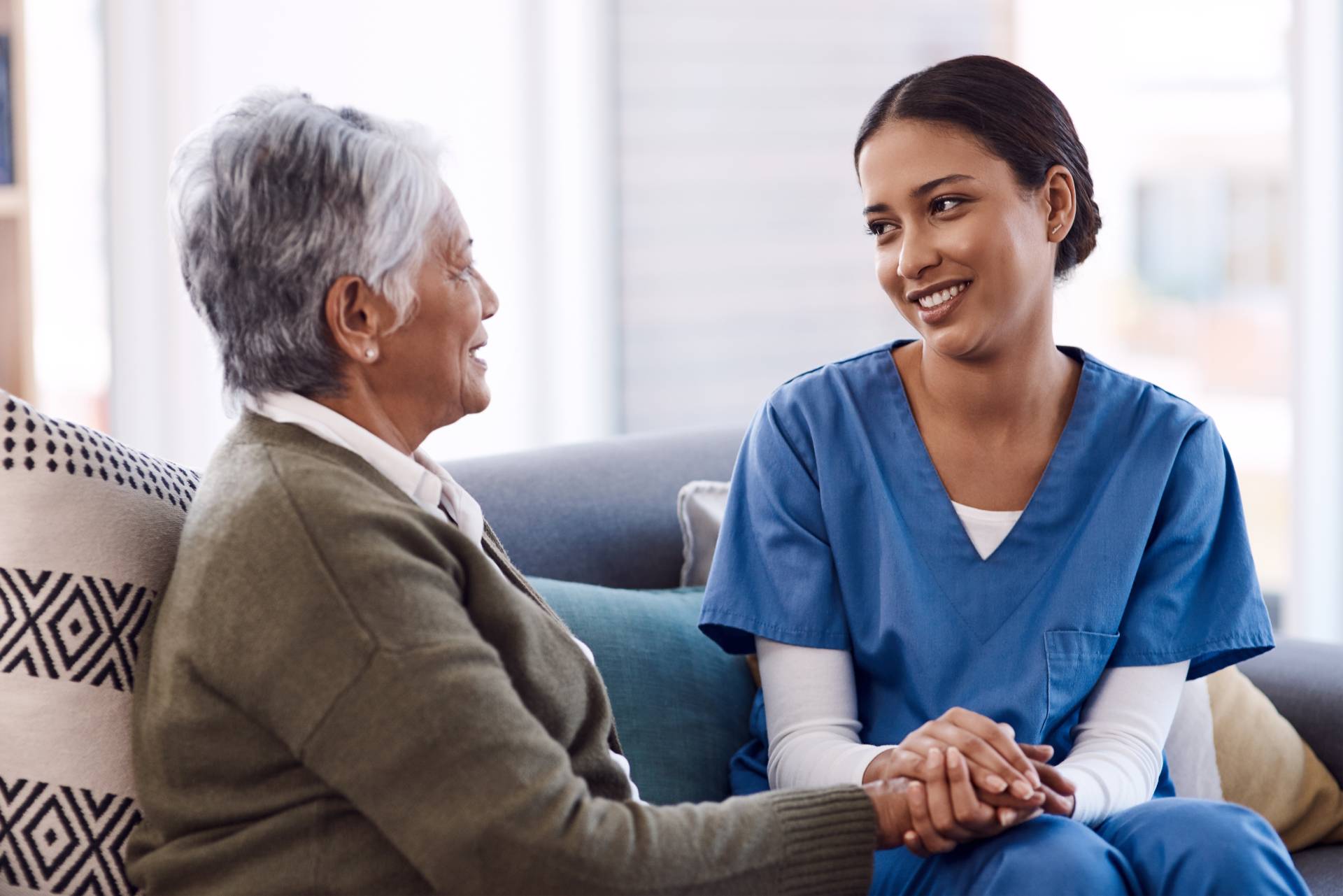 Elderly woman discusses a care plan with her nurse.