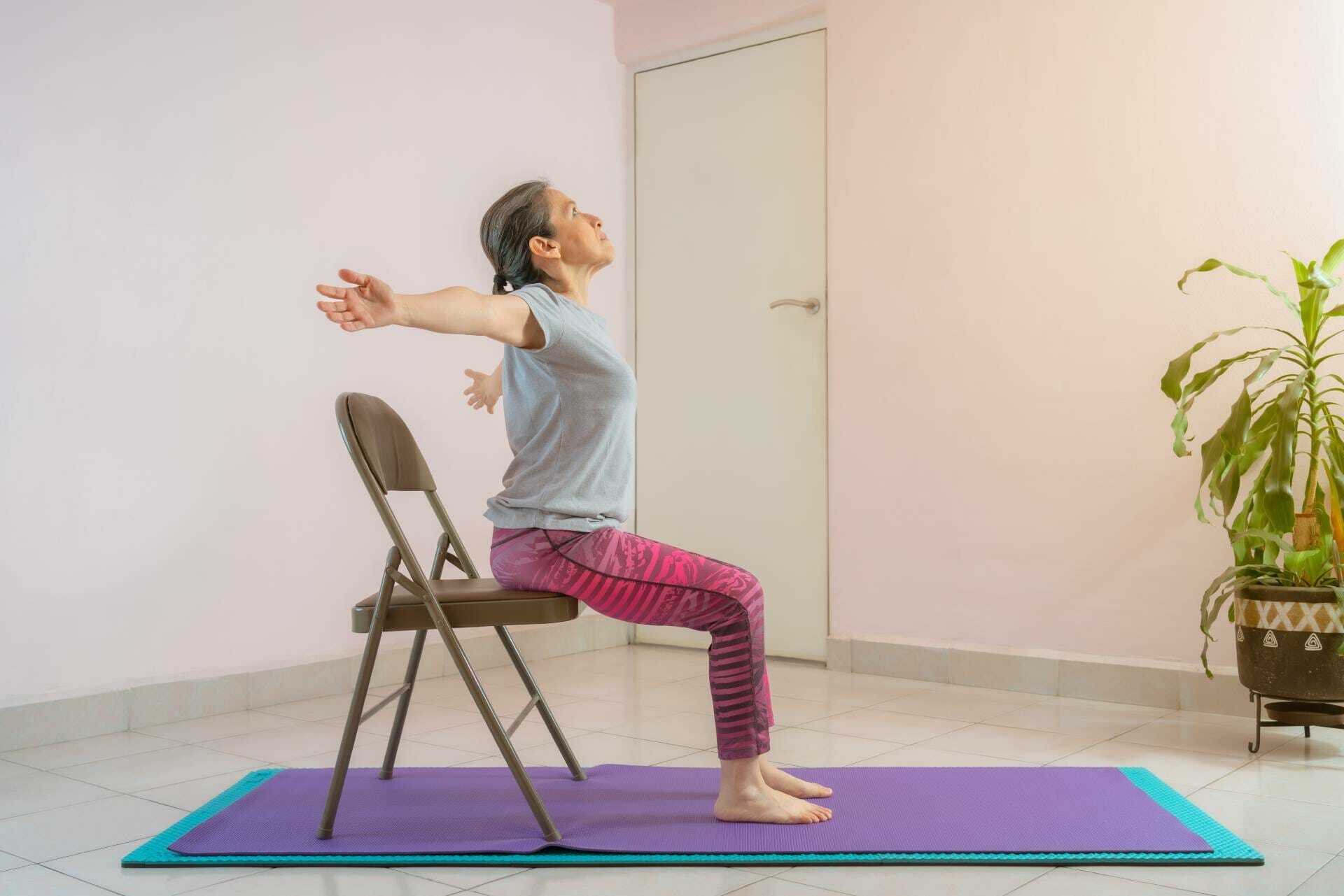 Senior woman leaning back on a chair in her living room.