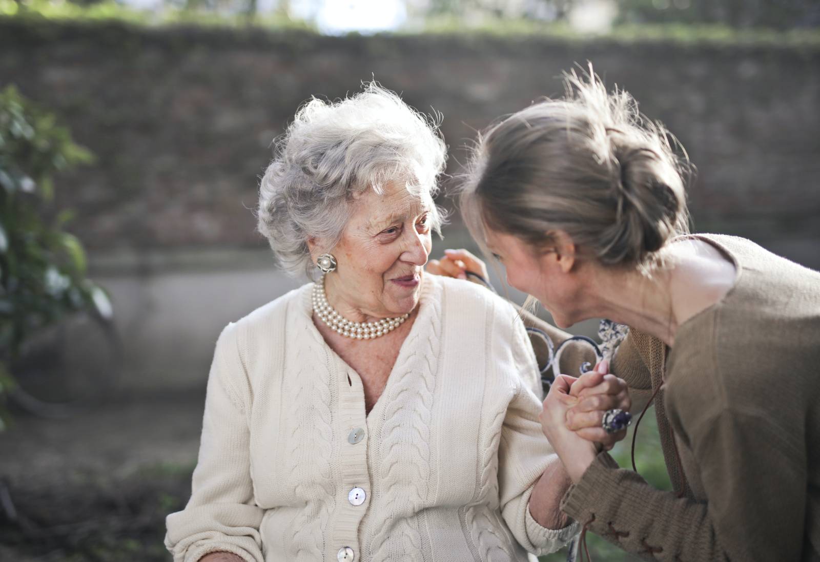 Senior with dementia laughing with their family caregiver.