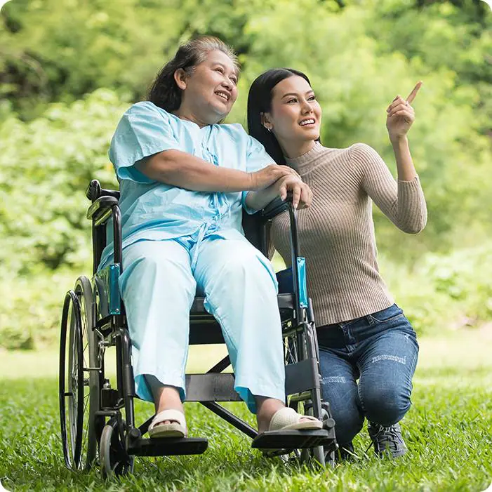 private-dementia-care-edmonton Elderly woman in a wheelchair with a caregiver who is providing private dementia care in Edmonton.