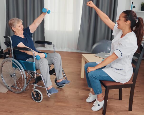 Caregiver and a woman exercising.