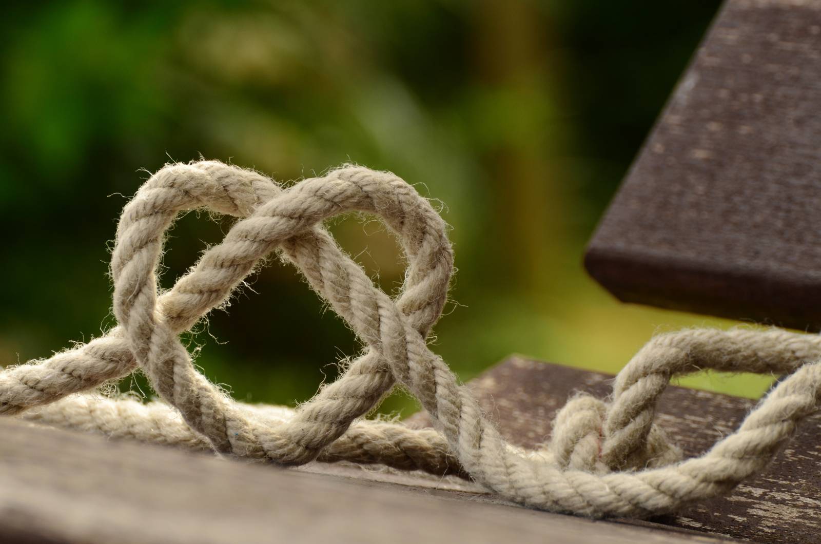 A knot in the shape of a heart on an outdoor table.