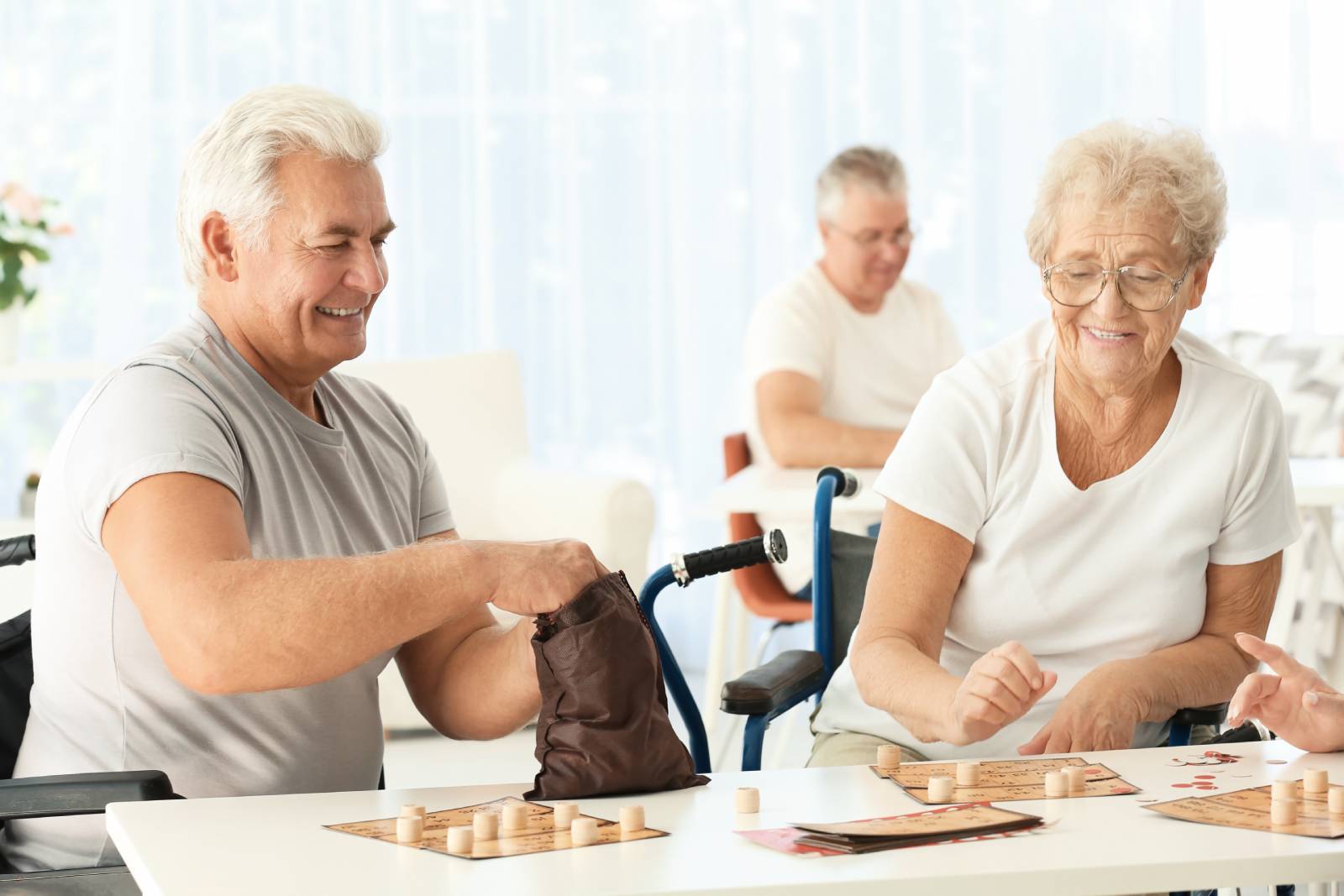 Senior woman and man playing bingo.