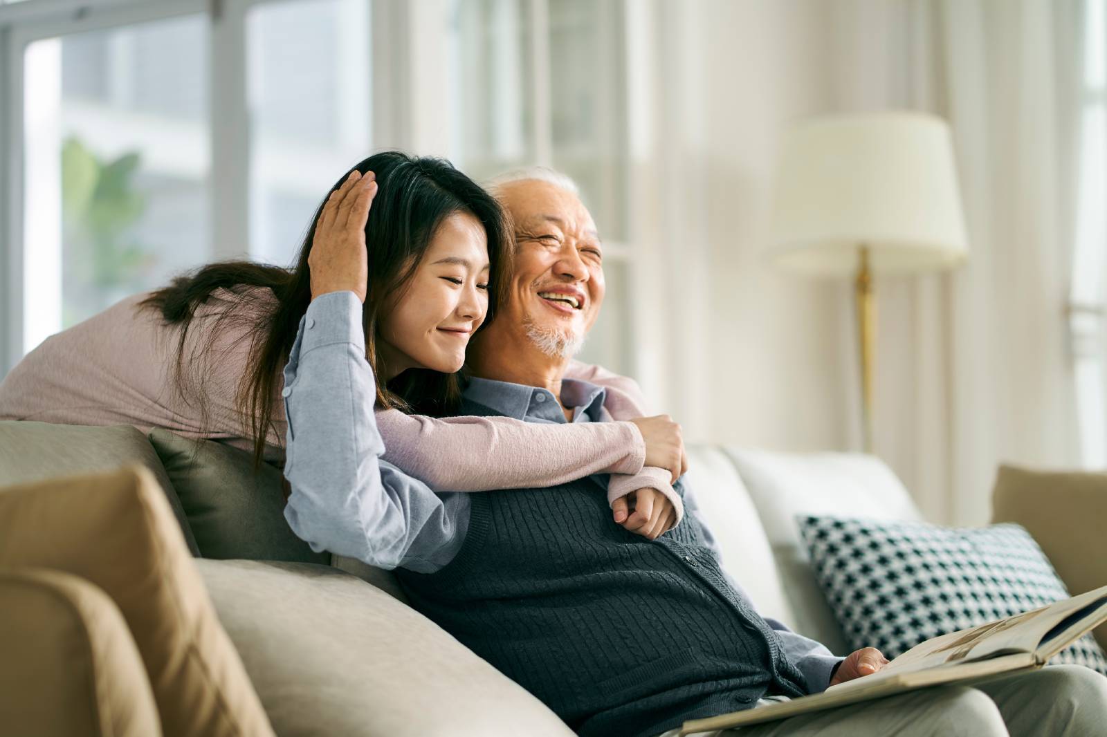 A daughter and her father hugging.