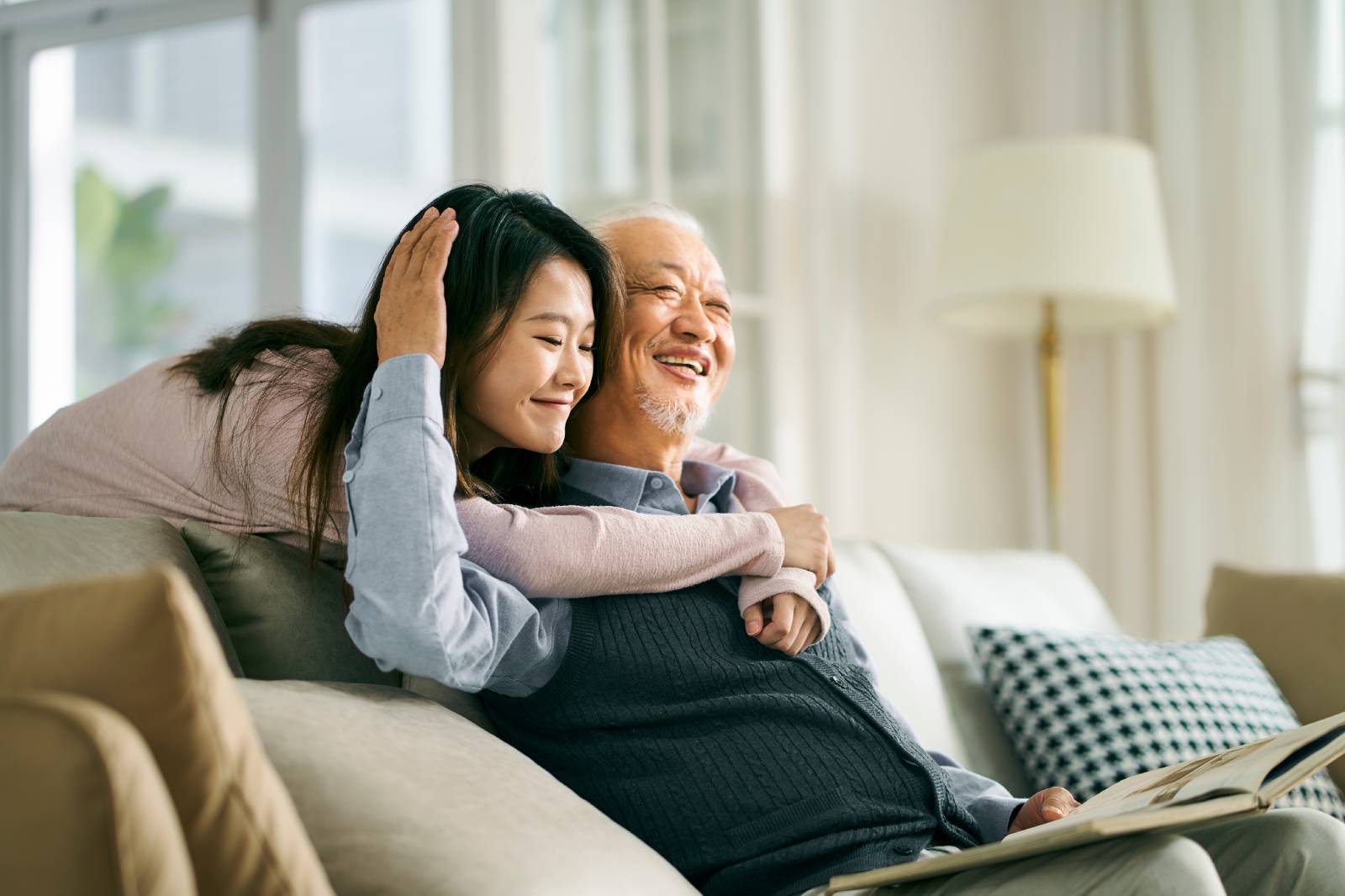 A daughter and her father hugging.