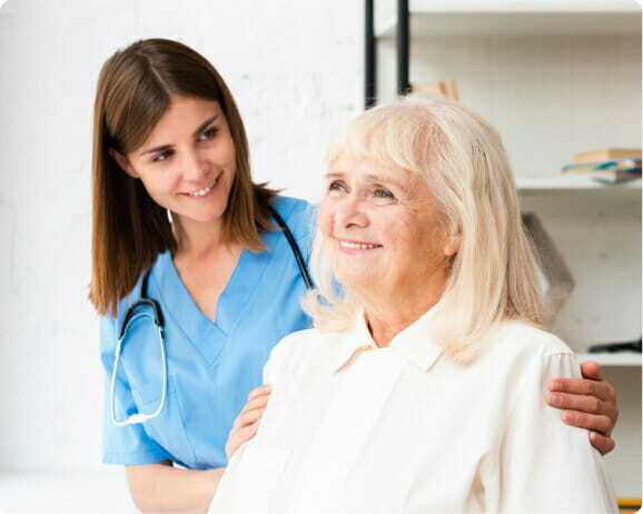 Old lady smiling with her caregiver.