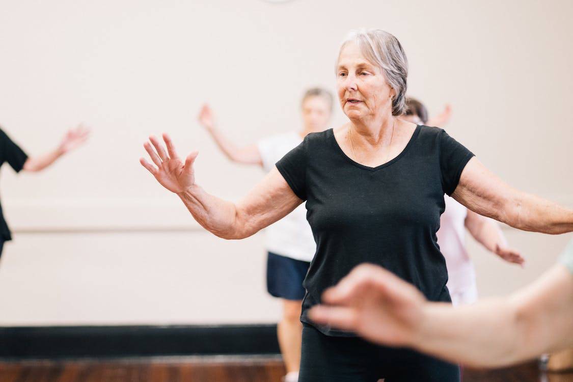Senior with dementia enjoying a light workout.