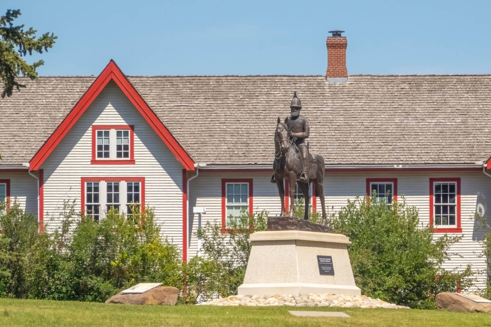 The Fort Calgary building with the statue of the man on a horse.